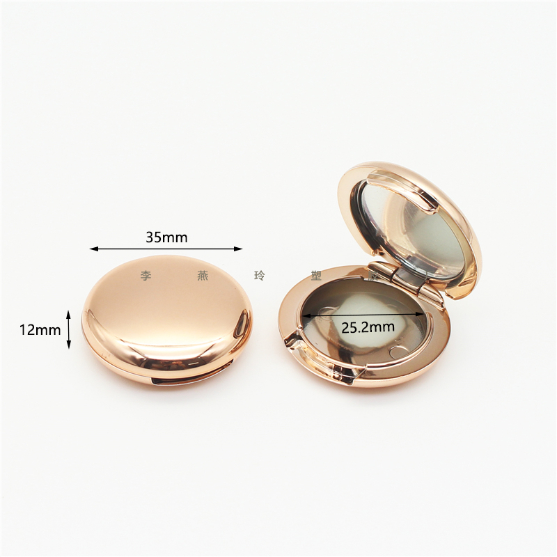 Round gold mirrored eye shadow box